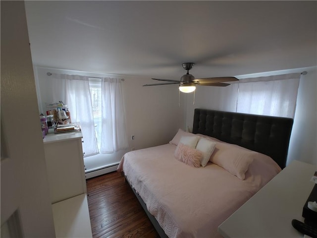 bedroom featuring a ceiling fan, a baseboard heating unit, and dark wood-type flooring