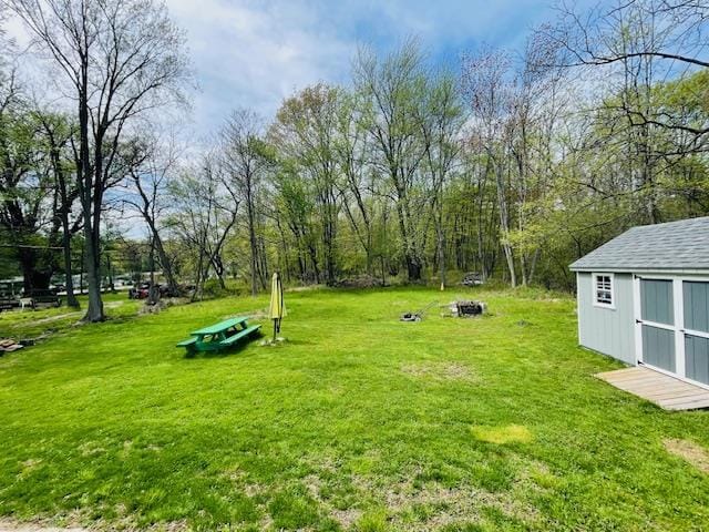 view of yard featuring an outbuilding and a shed