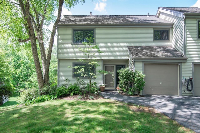 201 Hunters Run, Dobbs Ferry, NY 10522 - view of front of house with driveway, an attached garage, a front lawn, and roof with shingles