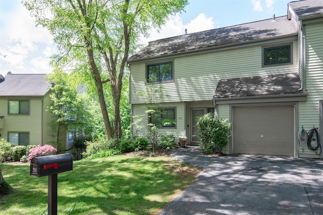 201 Hunters Run, Dobbs Ferry, NY 10522 - view of front facade featuring driveway, a front lawn, a garage, and a shingled roof