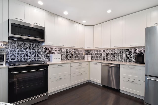 201 Hunters Run, Dobbs Ferry, NY 10522 - kitchen featuring stainless steel appliances, light countertops, a sink, dark wood-type flooring, and recessed lighting