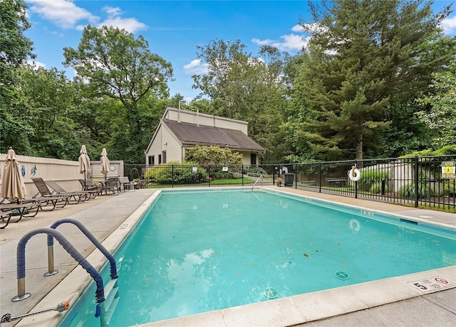 201 Hunters Run, Dobbs Ferry, NY 10522 - community pool featuring a patio, fence, and view of wooded area