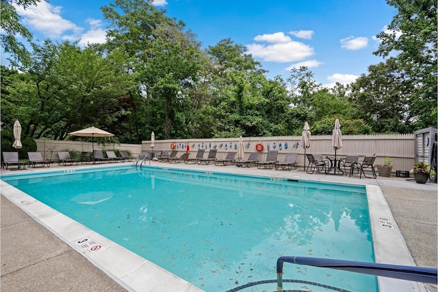 201 Hunters Run, Dobbs Ferry, NY 10522 - community pool with fence, a patio area, and view of scattered trees