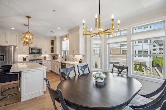 20105 Aspenwood Dr, Plainview, NY 11803 - dining room with a chandelier, light wood-type flooring, and recessed lighting