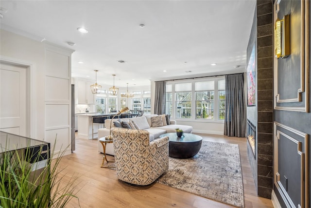 20105 Aspenwood Dr, Plainview, NY 11803 - living area featuring light wood-type flooring, recessed lighting, and a chandelier