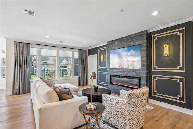 20105 Aspenwood Dr, Plainview, NY 11803 - living area featuring a fireplace, light wood-style floors, crown molding, baseboards, and recessed lighting