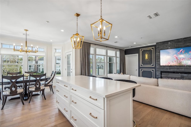 20105 Aspenwood Dr, Plainview, NY 11803 - kitchen featuring a chandelier, crown molding, recessed lighting, white cabinets, and light wood-style floors