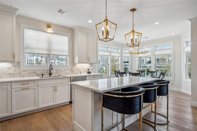 20105 Aspenwood Dr, Plainview, NY 11803 - kitchen featuring a sink, a chandelier, a kitchen island, healthy amount of natural light, and recessed lighting