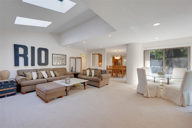 living area featuring carpet floors, recessed lighting, and vaulted ceiling with skylight