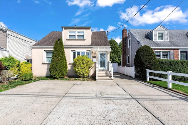 487 Emerson Pl, Valley Stream, NY 11580 - view of front of home featuring stucco siding, a shingled roof, and fence