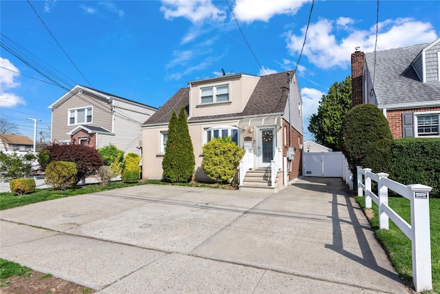 487 Emerson Pl, Valley Stream, NY 11580 - bungalow-style home featuring fence, a shingled roof, brick siding, entry steps, and a chimney