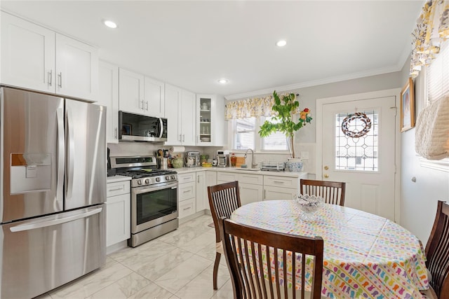 487 Emerson Pl, Valley Stream, NY 11580 - kitchen with appliances with stainless steel finishes, light countertops, white cabinets, marble finish floor, and glass insert cabinets