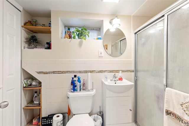 487 Emerson Pl, Valley Stream, NY 11580 - bathroom featuring wainscoting, toilet, tile walls, an enclosed shower, and a sink
