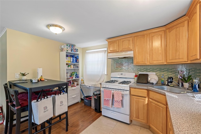 487 Emerson Pl, Valley Stream, NY 11580 - kitchen featuring white gas range oven, a sink, light countertops, decorative backsplash, and under cabinet range hood