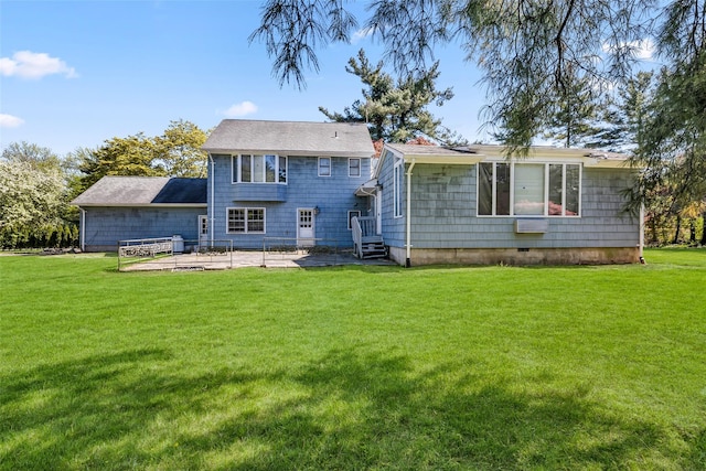 rear view of house with a lawn and a patio area