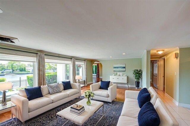 137 Melbury Rd, Babylon, NY 11702 - living area with arched walkways, crown molding, a water view, and recessed lighting