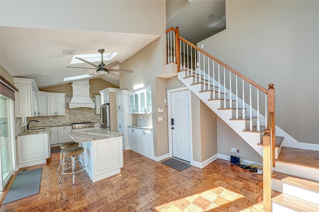137 Melbury Rd, Babylon, NY 11702 - kitchen with premium range hood, a skylight, tasteful backsplash, freestanding refrigerator, and a ceiling fan