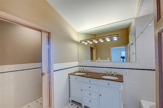 137 Melbury Rd, Babylon, NY 11702 - full bath with tile walls, double vanity, a tub, and a wainscoted wall