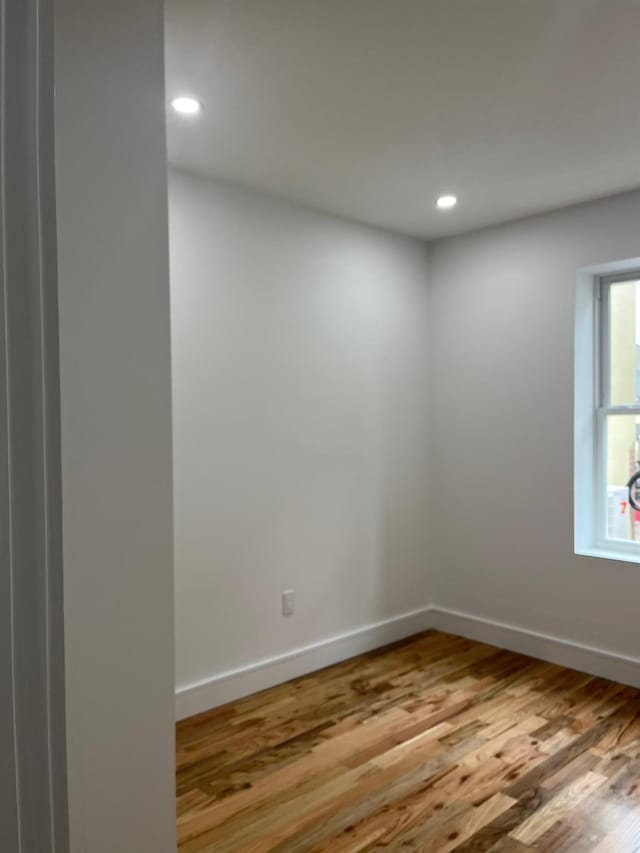 53-12 103rd St, Corona, NY 11368 - spare room with wood finished floors, recessed lighting, and baseboards