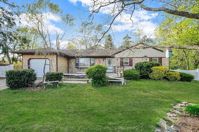 ranch-style home with a garage, fence, and a front lawn