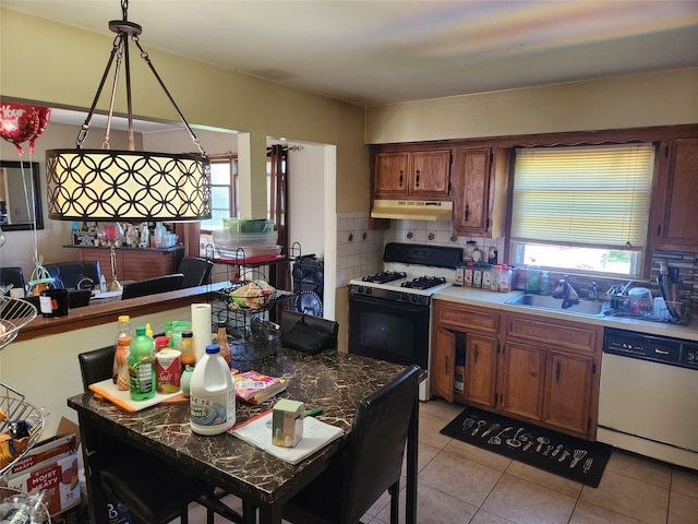kitchen with range with gas stovetop, white dishwasher, under cabinet range hood, tasteful backsplash, and a sink