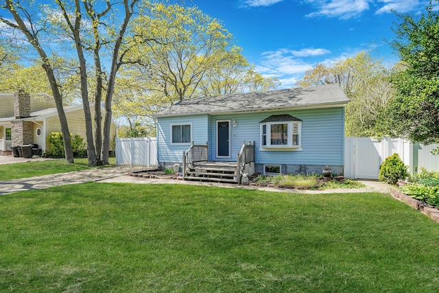view of front of property with fence and a front lawn