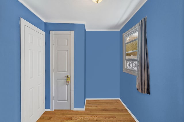 unfurnished bedroom featuring baseboards and wood finished floors