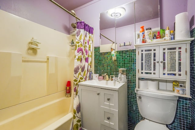 bathroom featuring vanity, toilet, shower / tub combo, and tile walls