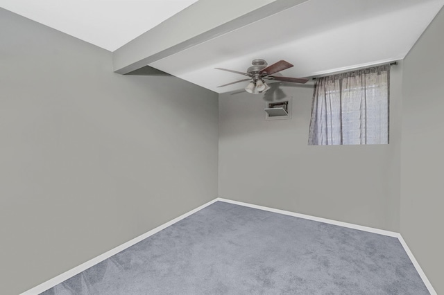 carpeted empty room featuring baseboards, ceiling fan, and visible vents