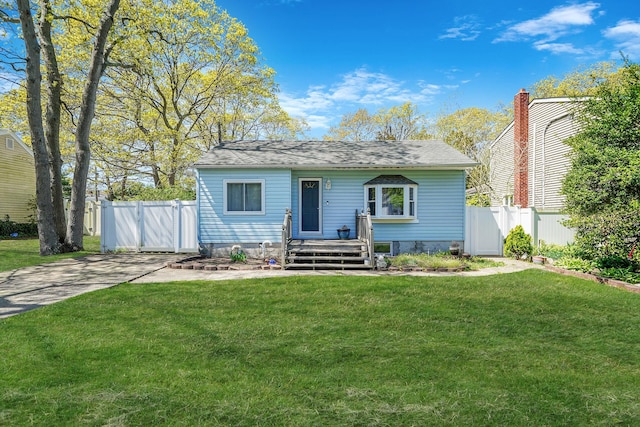 view of front of home with fence, a wooden deck, a gate, and a front lawn