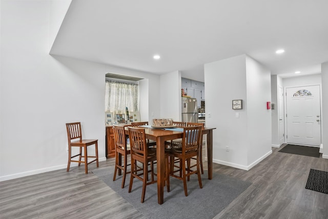 dining area with baseboards, recessed lighting, and wood finished floors