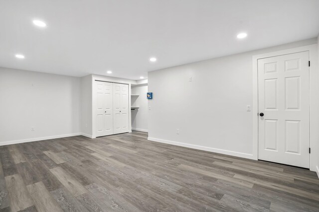 finished basement with baseboards, recessed lighting, and wood finished floors