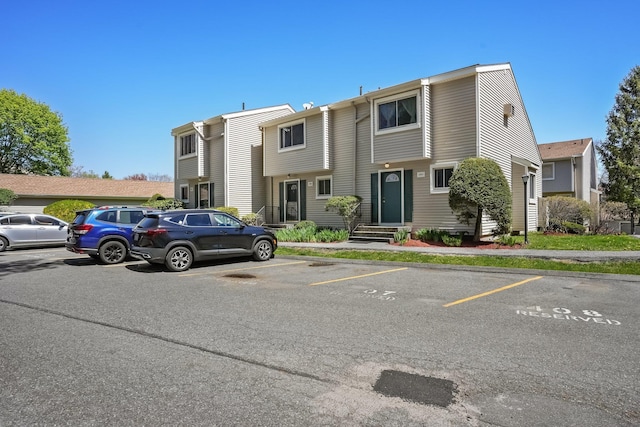 view of property with uncovered parking
