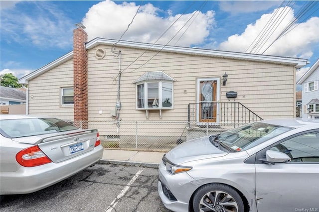 33 Alden Park Unit 33, Bronx, NY 10465 - view of front of home with a fenced front yard and a chimney