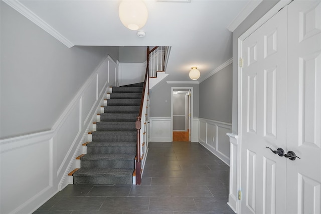 149 King St Unit 15, Chappaqua, NY 10514 - stairway with a decorative wall, ornamental molding, wainscoting, and tile patterned floors