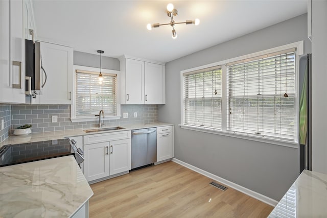 149 King St Unit 15, Chappaqua, NY 10514 - kitchen with stainless steel appliances, a sink, healthy amount of natural light, and light wood-style flooring