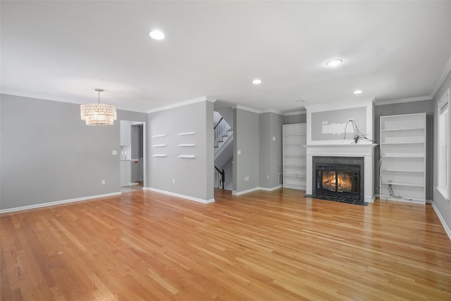 149 King St Unit 15, Chappaqua, NY 10514 - unfurnished living room with a fireplace, stairway, light wood-style floors, a chandelier, and recessed lighting
