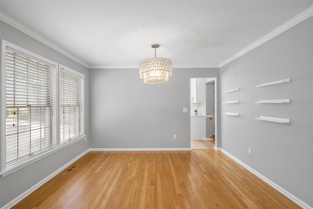 149 King St Unit 15, Chappaqua, NY 10514 - unfurnished room with a chandelier, light wood-type flooring, crown molding, and baseboards