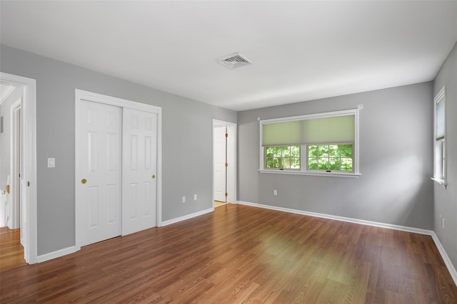 149 King St Unit 15, Chappaqua, NY 10514 - unfurnished bedroom with wood finished floors, baseboards, and a closet