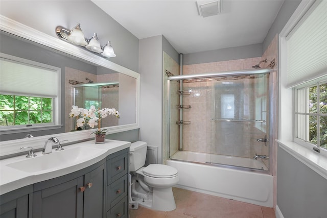 149 King St Unit 15, Chappaqua, NY 10514 - bathroom with toilet, tile patterned flooring, vanity, and bath / shower combo with glass door