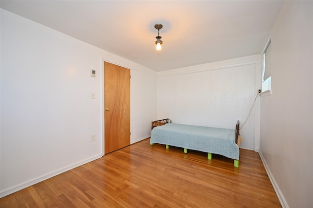 1918 Utopia Pkwy, Whitestone, NY 11357 - bedroom featuring light wood-type flooring and baseboards