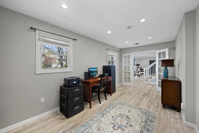 office area featuring baseboards, french doors, and wood finished floors
