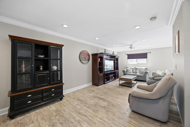 living area with baseboards, ornamental molding, ceiling fan, and light wood-type flooring