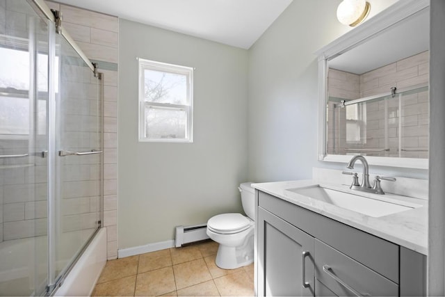 bathroom featuring vanity, a baseboard radiator, baseboards, tile patterned floors, and toilet