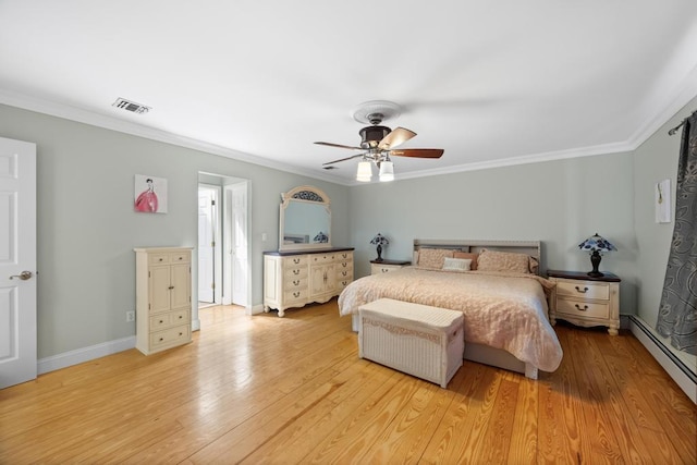 bedroom featuring visible vents, ornamental molding, and a baseboard heating unit