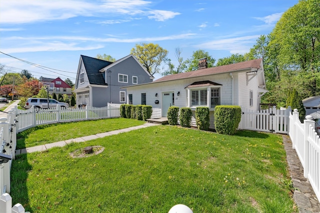 15 Elmore Ave, Croton-On-Hudson, NY 10520 - view of front of home featuring a fenced backyard, a front lawn, and a chimney