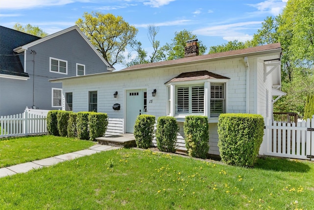 15 Elmore Ave, Croton-On-Hudson, NY 10520 - view of front facade with fence, a chimney, and a front yard