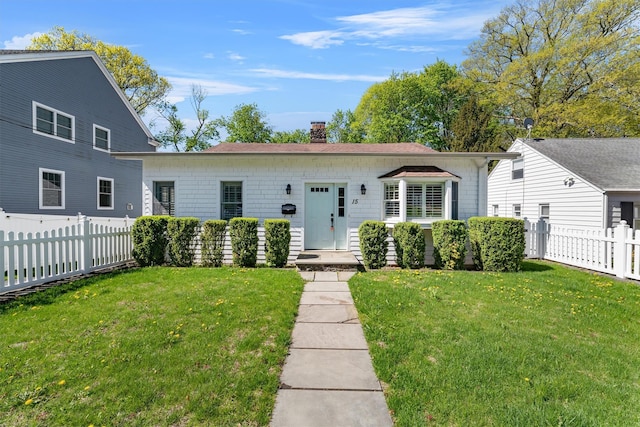 15 Elmore Ave, Croton-On-Hudson, NY 10520 - view of front facade featuring a chimney, a front yard, and fence