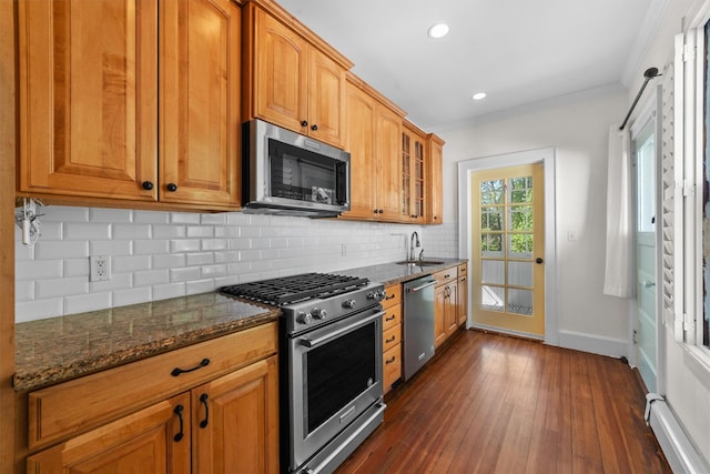 15 Elmore Ave, Croton-On-Hudson, NY 10520 - kitchen featuring a baseboard radiator, a sink, dark stone countertops, stainless steel appliances, and dark wood-style floors