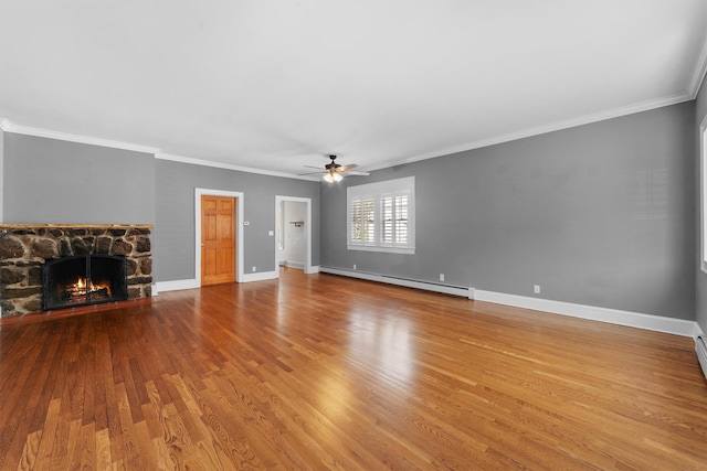 15 Elmore Ave, Croton-On-Hudson, NY 10520 - unfurnished living room featuring a baseboard heating unit, wood finished floors, a ceiling fan, a stone fireplace, and baseboards